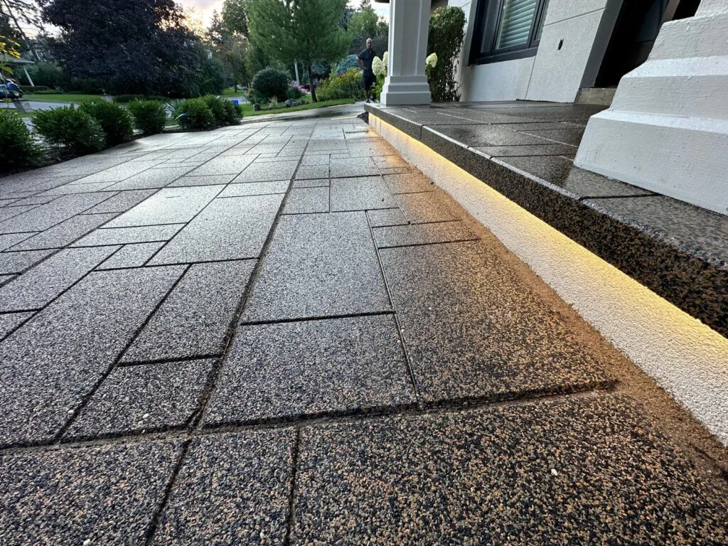 close up of interlocking on ground in front of entryway steps